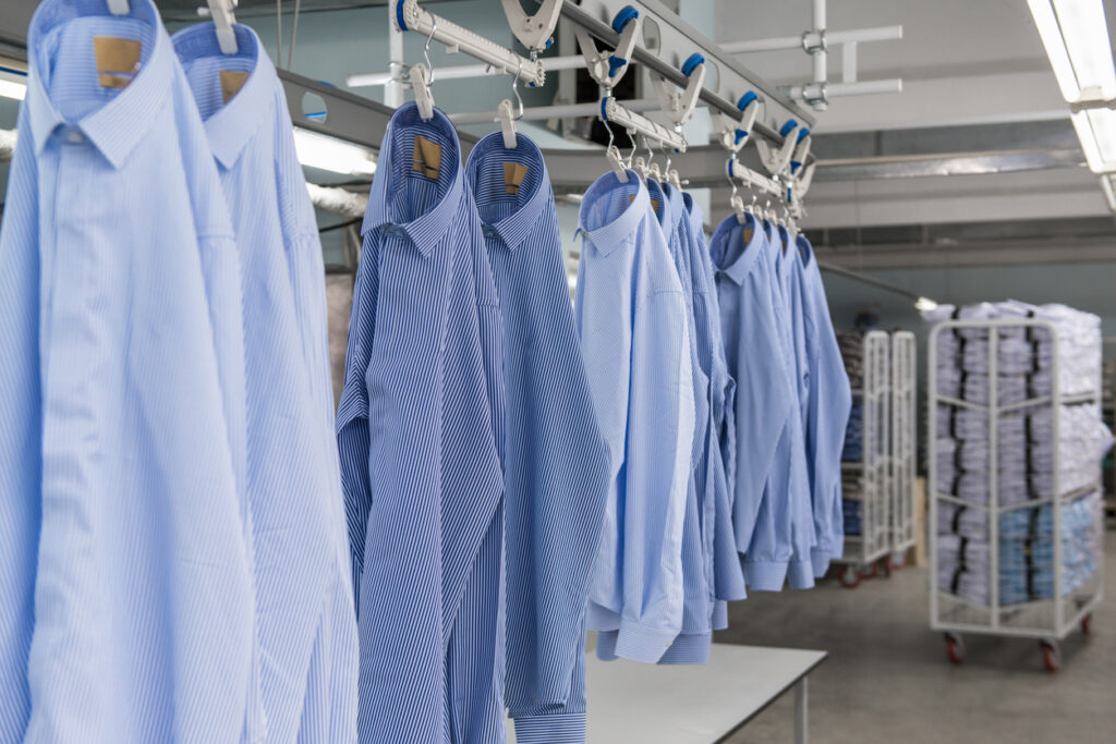 Image of shirts on assembly line in clothing factory.